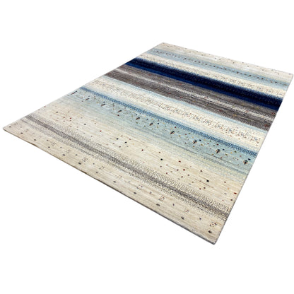 Gabbeh rug with a striped pattern in blue, gray, and cream, viewed up close