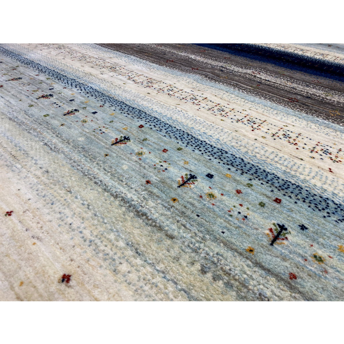 Close-up: Gabbeh rug with a dense pile, speckled dots, and blue stripes
