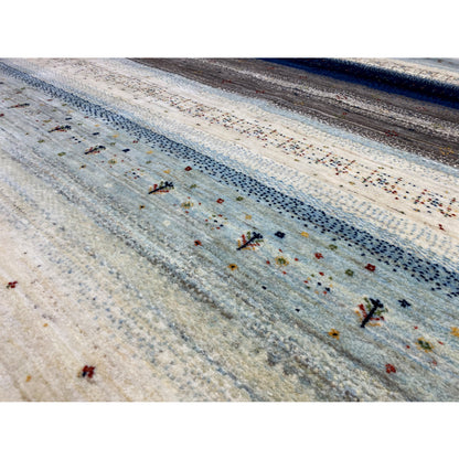 Close-up: Gabbeh rug with a dense pile, speckled dots, and blue stripes