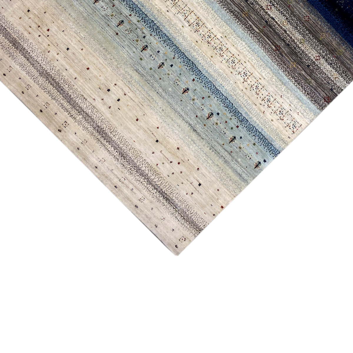 Gabbeh rug with fine vertical and horizontal stripes in cream and blue, photographed at an angle