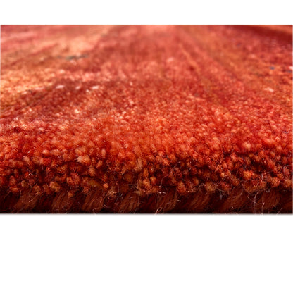 Close-up of the pile: red Gabbeh rug with a dense, high-pile weave structure