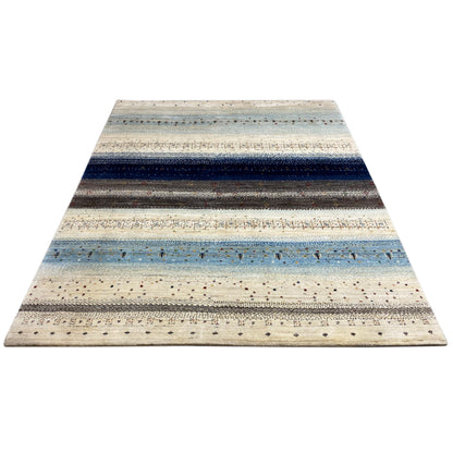 Rug in cream, blue and dark gray with wide stripes and fine flecks of color