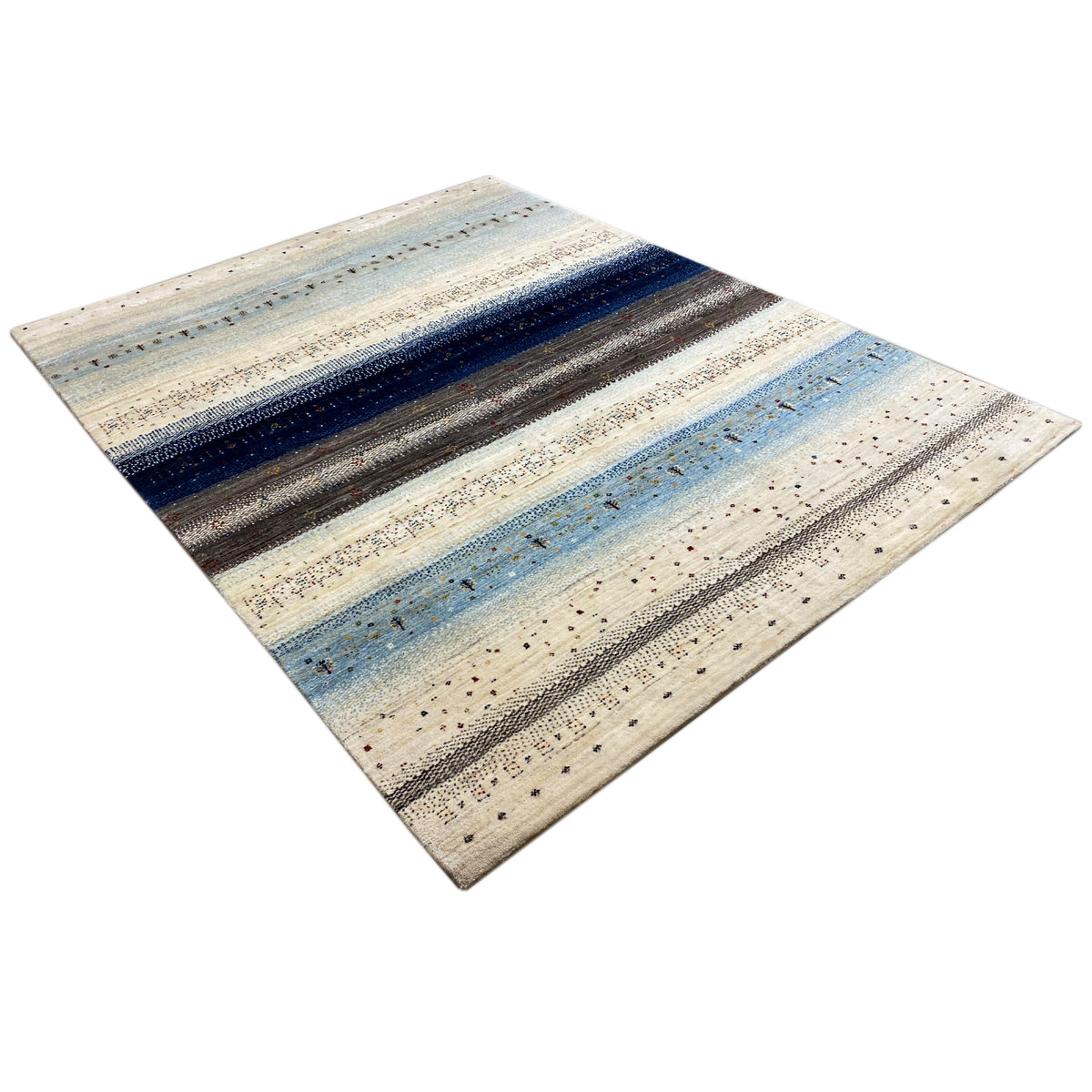Gabbeh rug laid flat, with a striped pattern in blue, gray, and cream