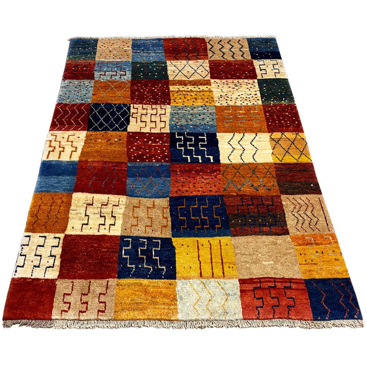 Gabbeh rug, rectangular, patchwork design with geometric patterns in blue, red, and yellow