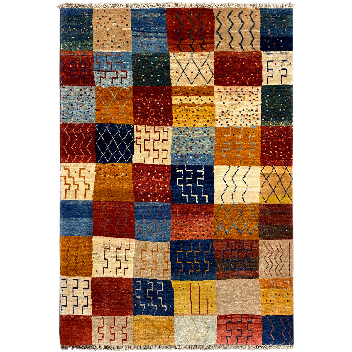 Gabbeh rug with colorful patchwork of diamond patterns, light-colored tassels along the edges