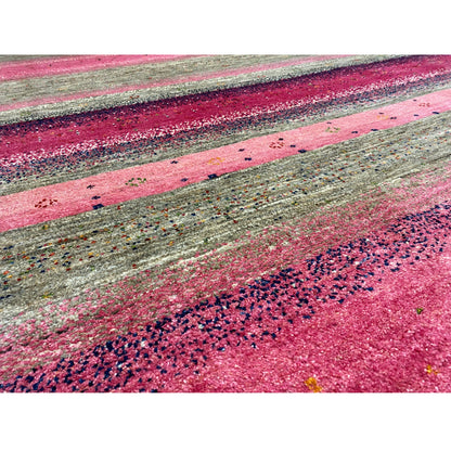 Close-up of Gabbeh rug: pink and gray stripes with a fine, irregular texture