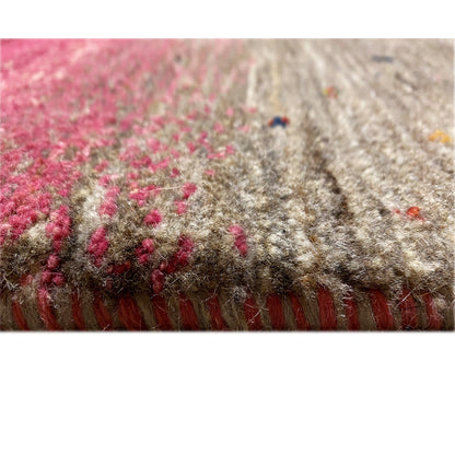 Close-up of a carpet surface with pink elements and gray pile, edge area visible