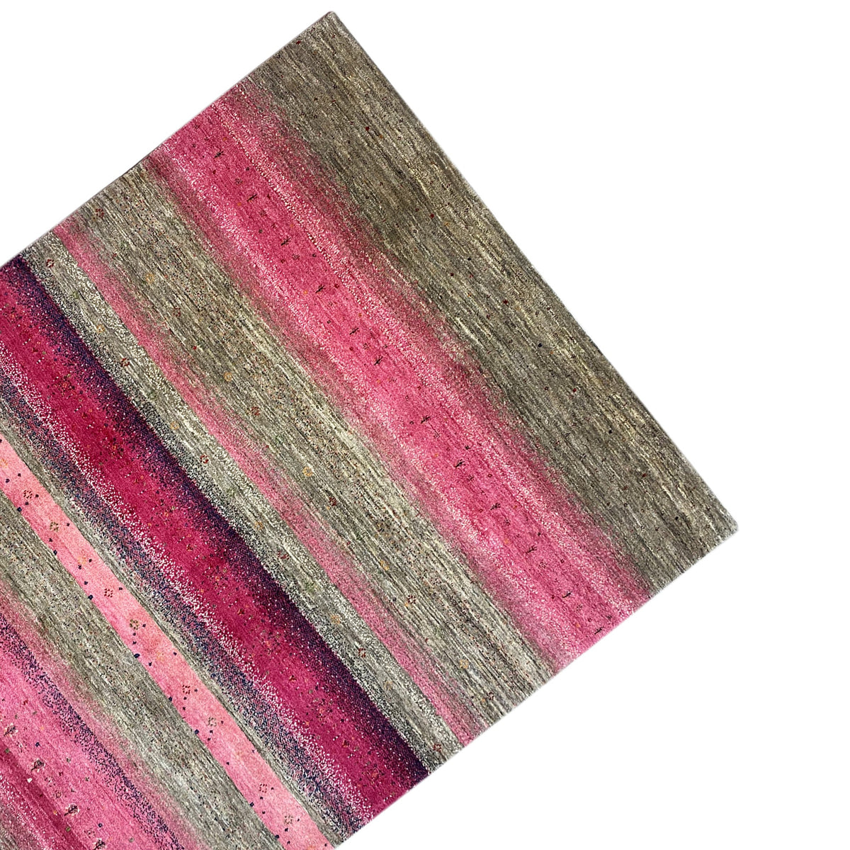 Gabbeh rug, photographed at an angle: pink stripes between gray stripes, textured pile