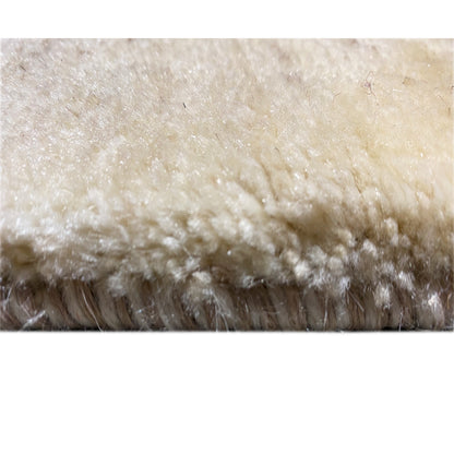 Close-up of a Gabbeh rug's pile and fringe edge, light beige with a short pile