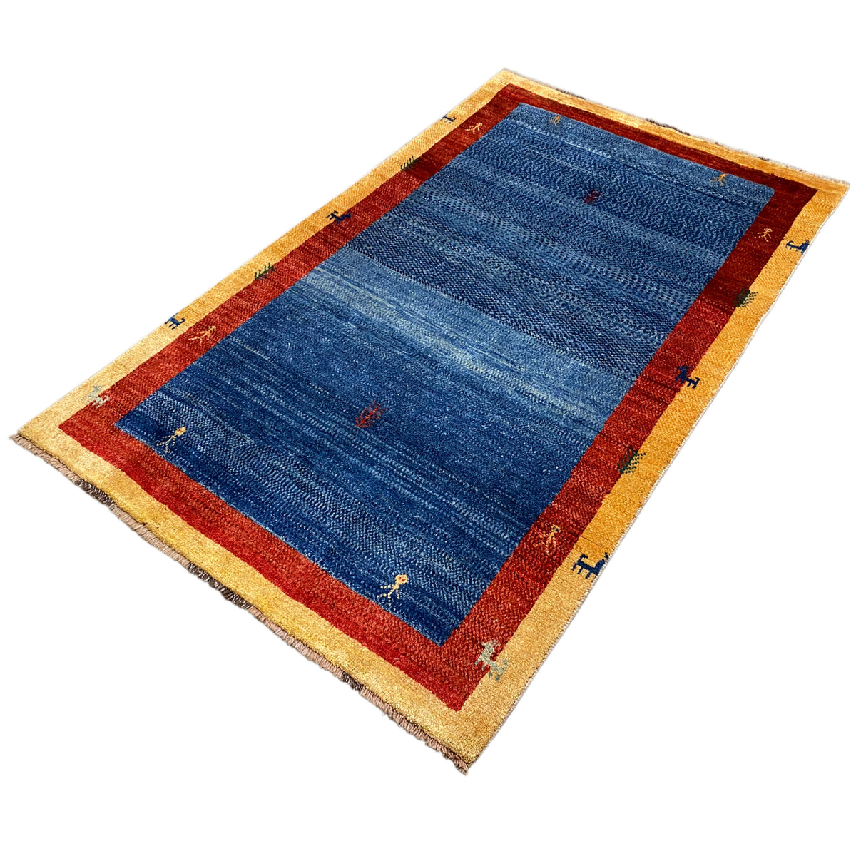 Carpet from above at an angle: blue field, red border, beige trim with small symbols