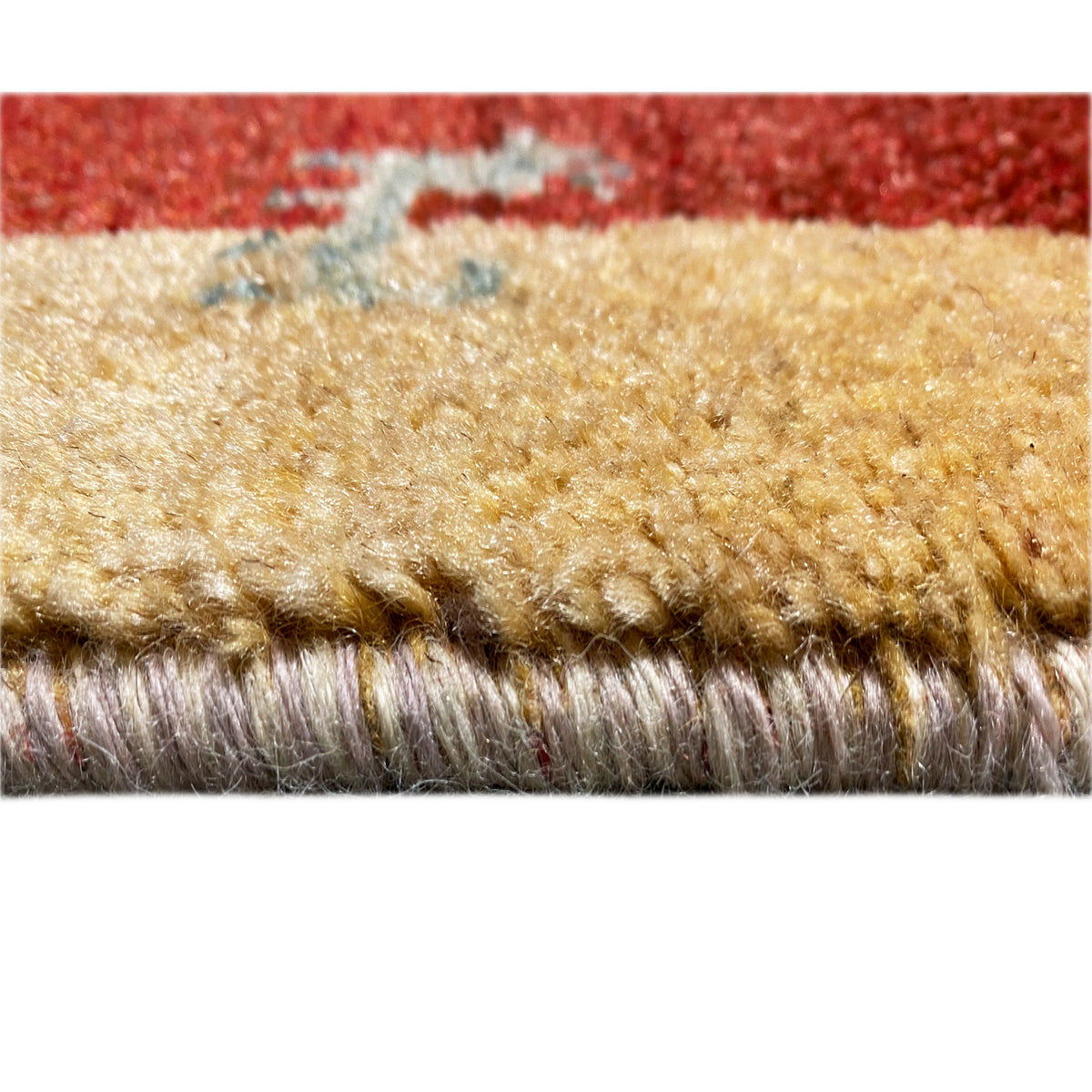Carpet edge with dense pile and short protruding fibers, red-beige edging
