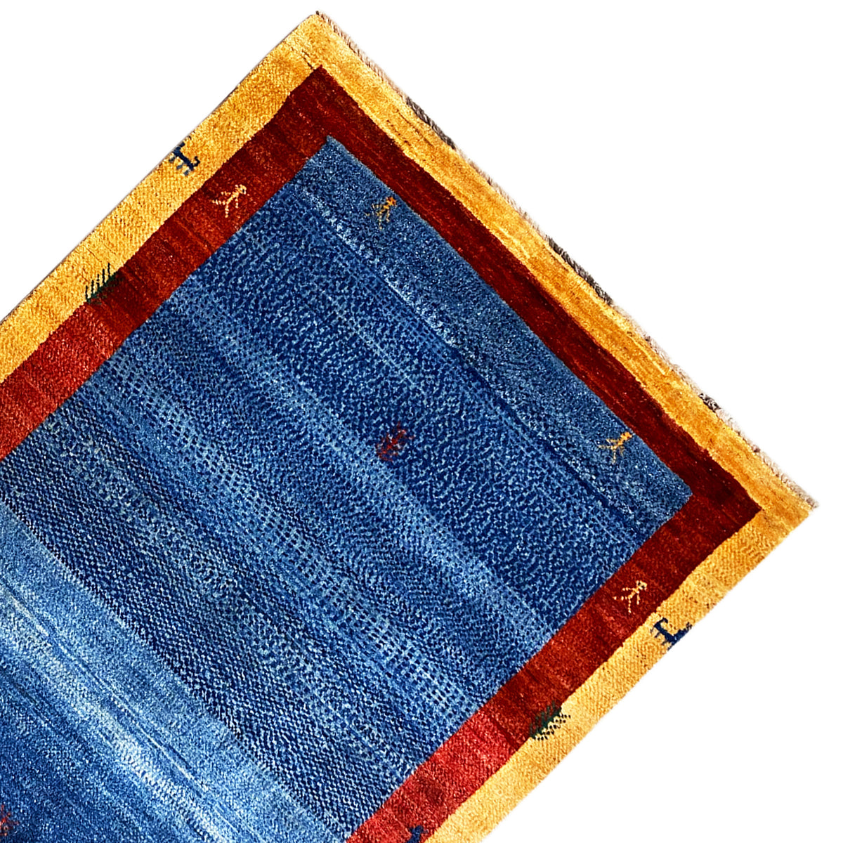 Corner of the carpet with a blue inner field, red border, and beige edging