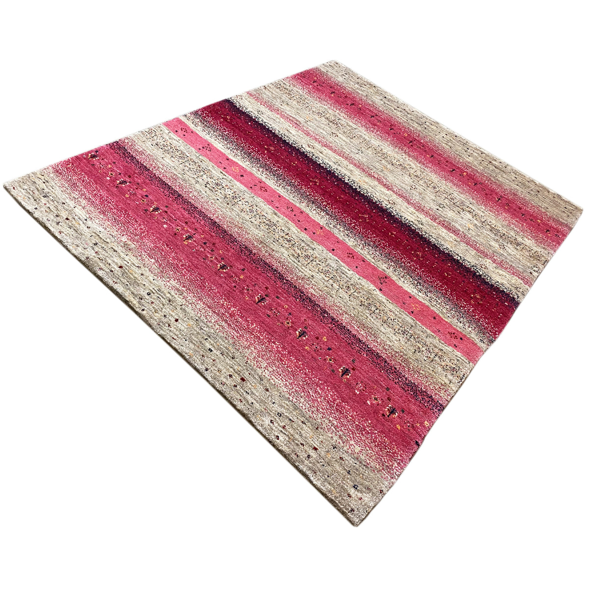 Gabbeh rug at an angle, red and beige stripes with dark accents