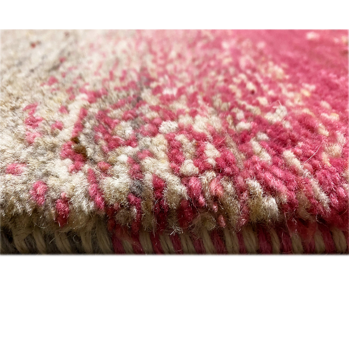 Close-up of the pile edge of the Gabbeh rug, red-and-beige velour with fringes