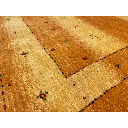 Rug detail: ochre-colored area with fine thread markings and small multicolored dots