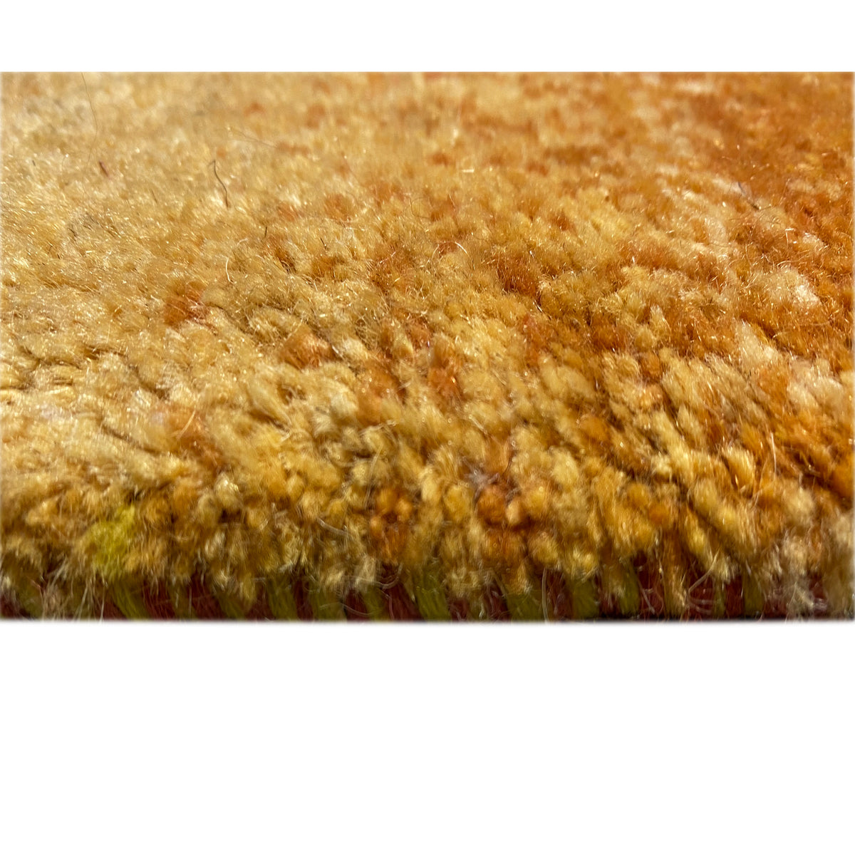 Carpet fiber detail: dense pile in warm ochre with visible texture