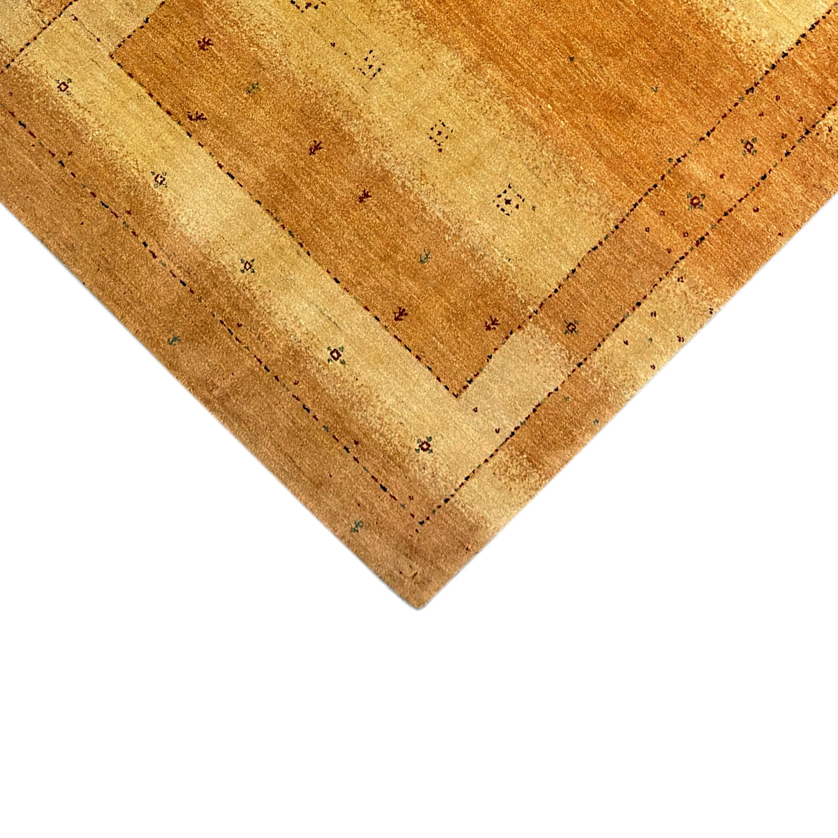 Close-up of carpet edge: border lines and pattern dots in ochre/beige