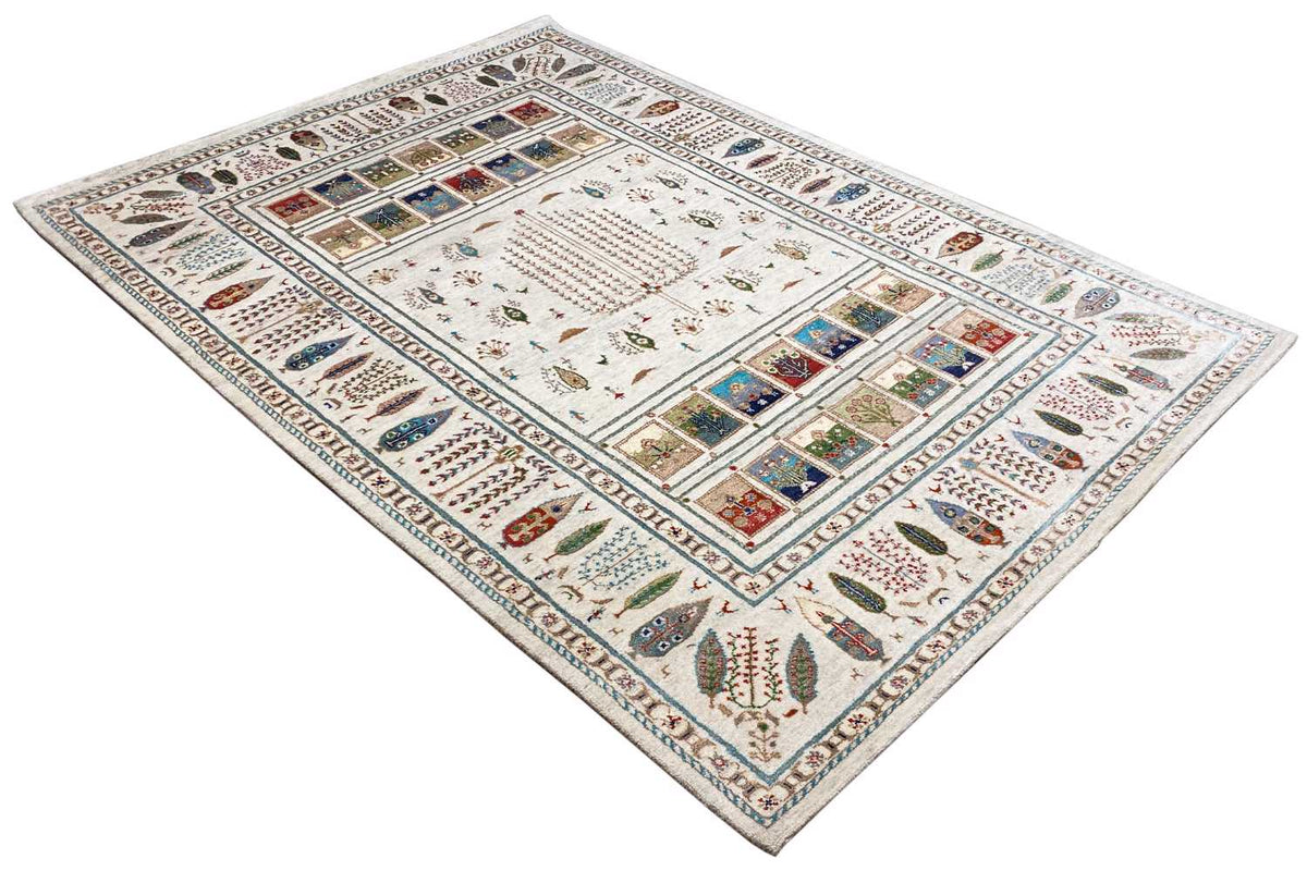 Gabbeh rug in beige/cream with a symmetrical pattern and blue and red accents