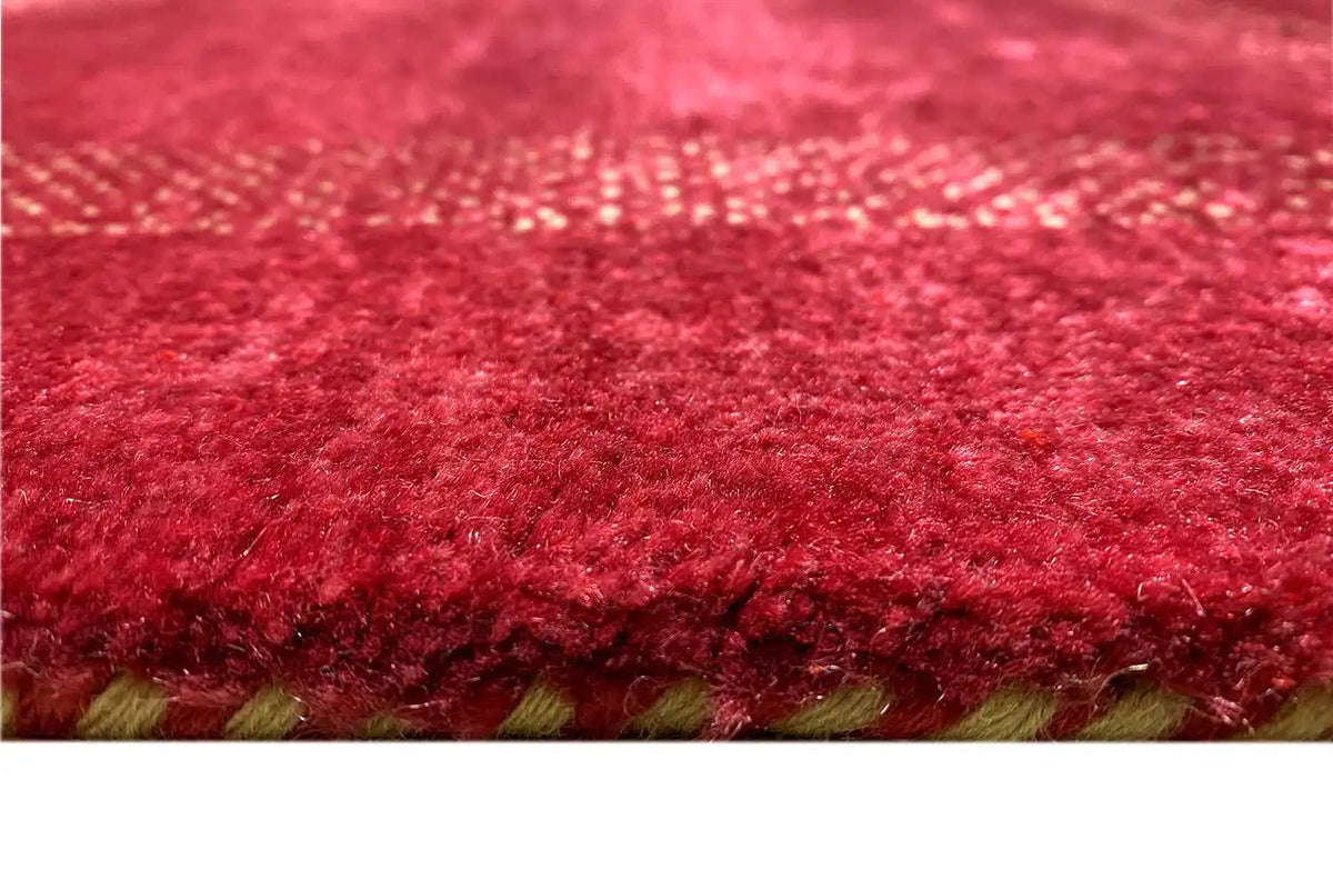 Lori gabbeh rug with red pile and a visible fringed border