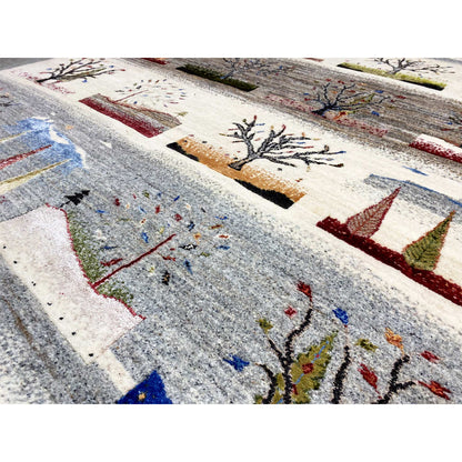 Close-up of a Gabbeh rug: gray areas with embroidered trees and colored dots