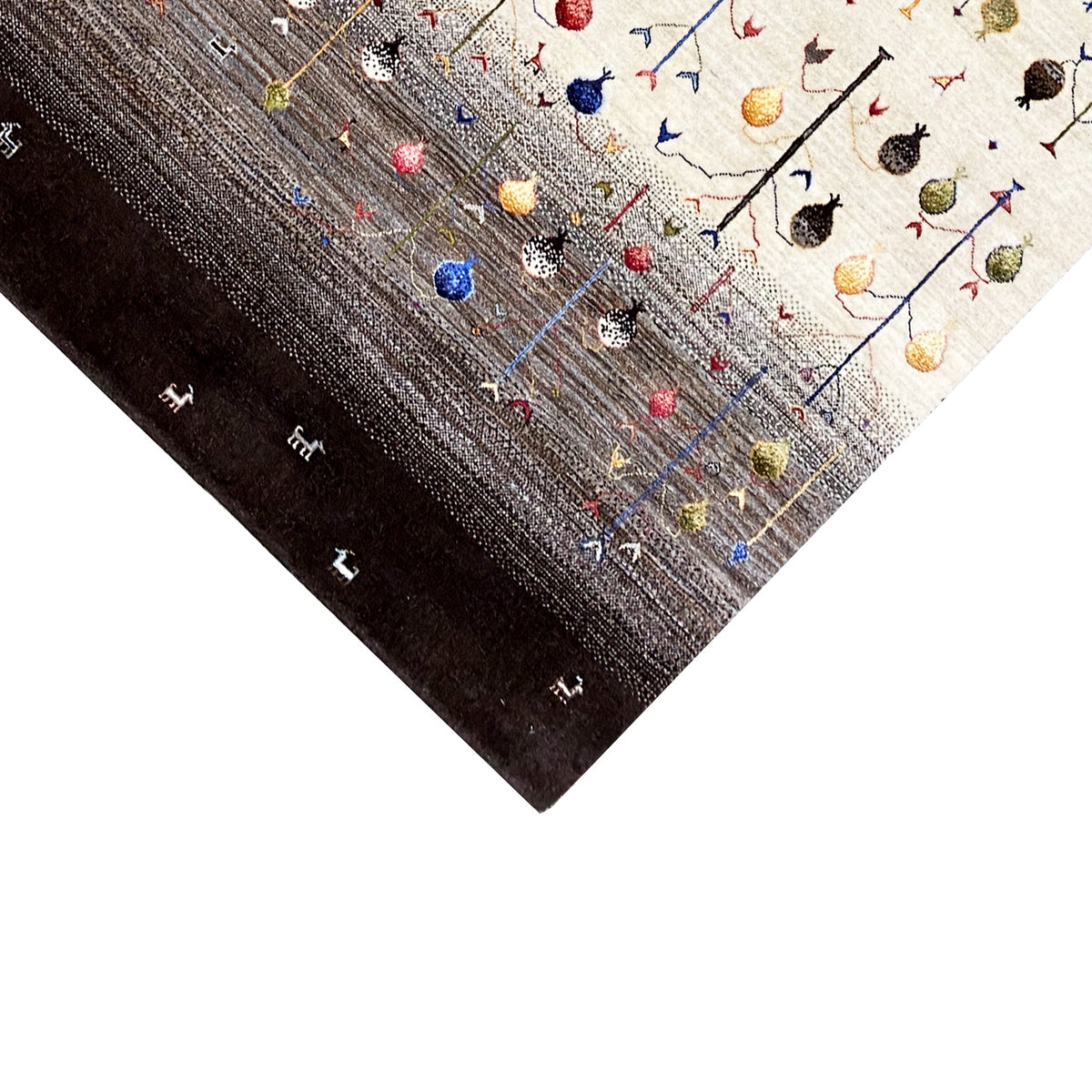 Gabbeh rug corner with colorful animal motifs on a light background and a dark border.