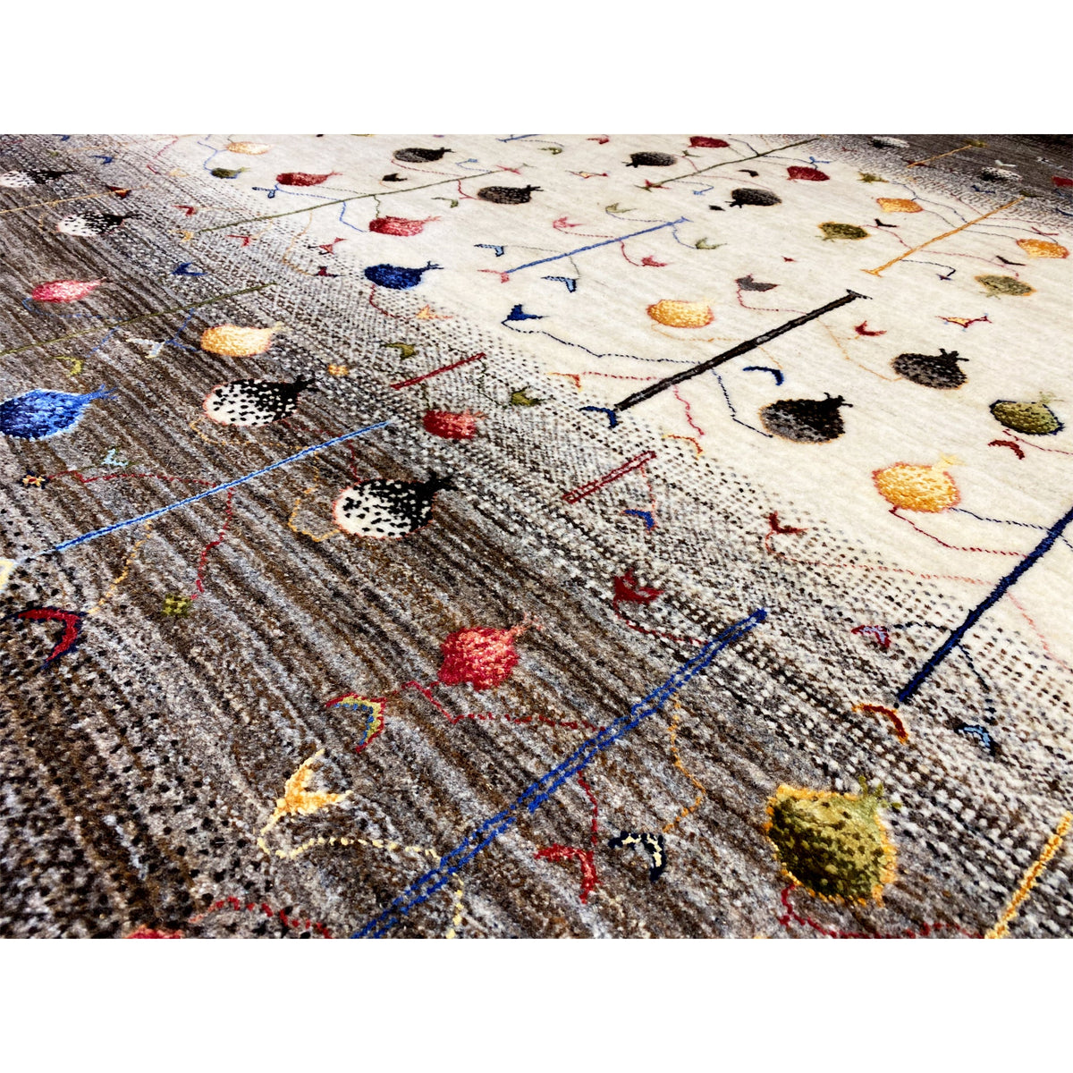 Gabbeh rug detail with a knotted texture, colorful motifs, and a blue linear grid.