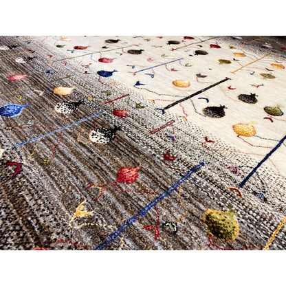 Gabbeh rug detail with a knotted texture, colorful motifs, and a blue linear grid.