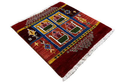 Red Gabbeh rug, central blue pattern with four squares, house motifs, white fringes