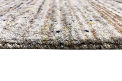 Gabbeh rug pile view at the edge, mottled gray with a fine woven texture