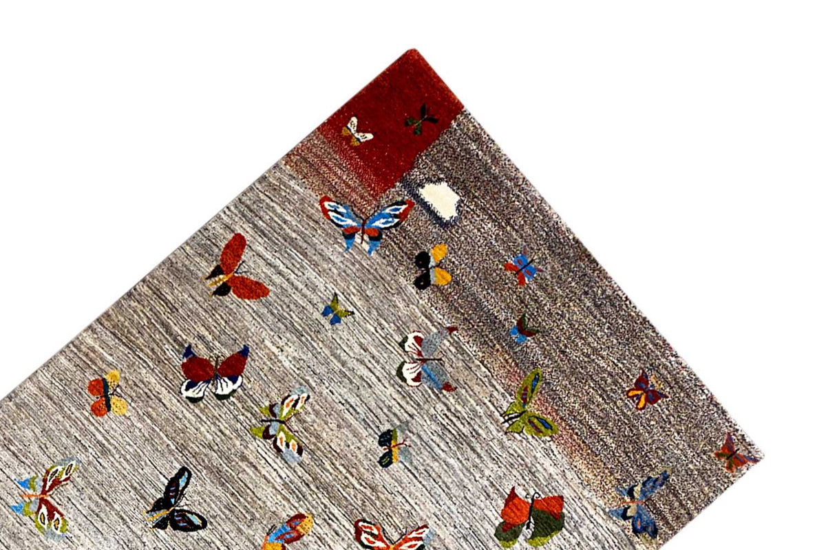 Gabbeh rug corner with a red accent, light gray with colorful butterflies