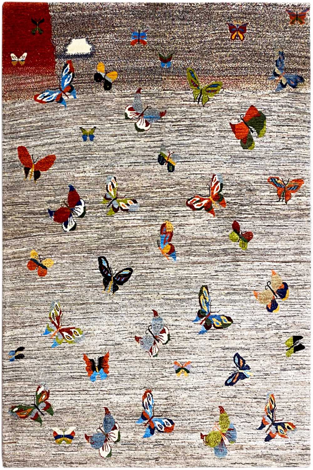 Gabbeh rug with a colorful butterfly pattern on a light background