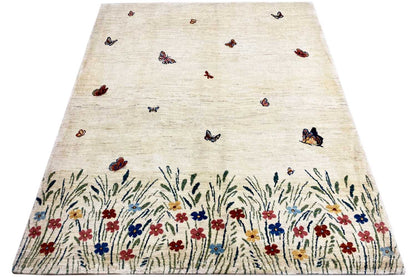 Gabbeh Lori rug: beige wool rug with butterflies and a multicolored floral and grass border
