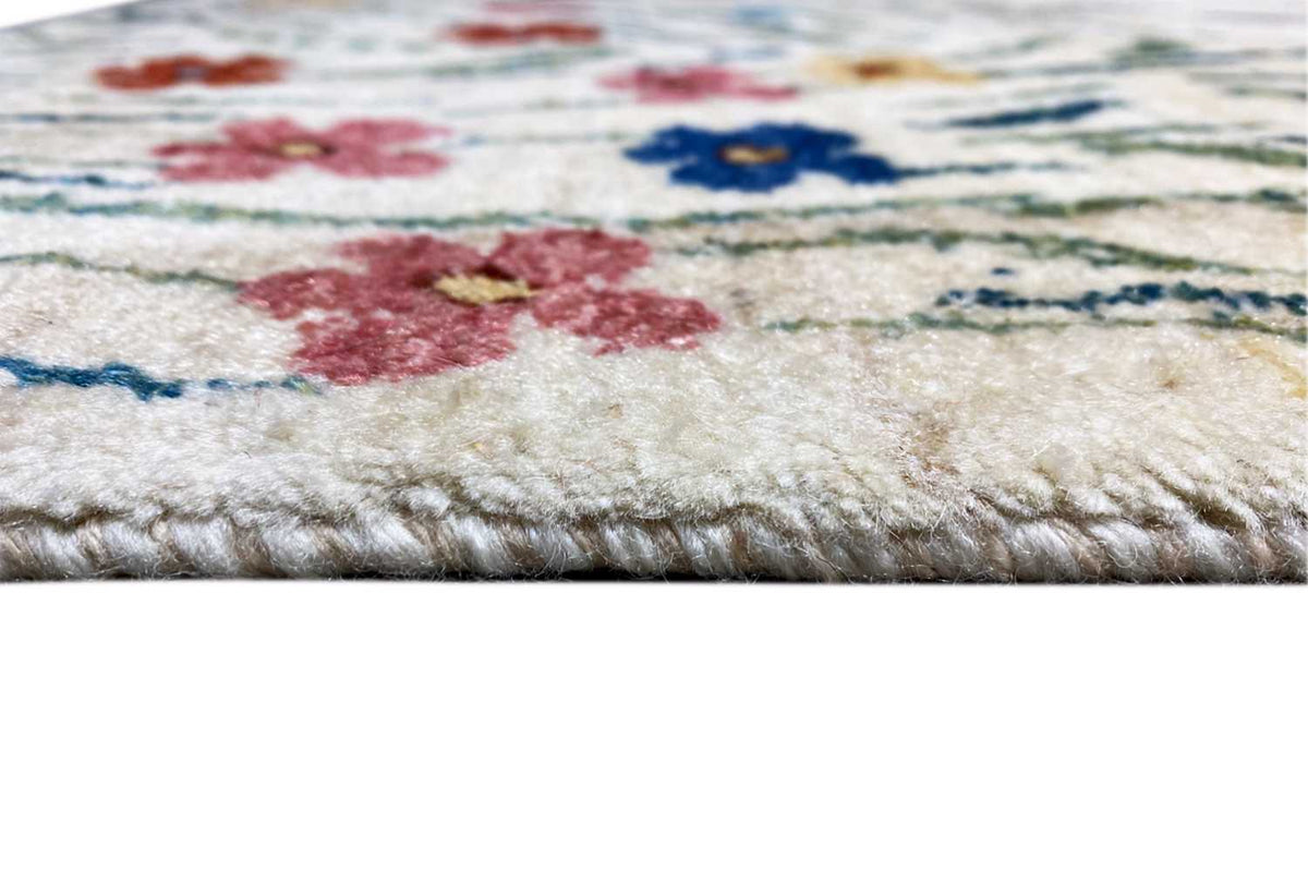Gabbeh-Lori rug: Detail of the selvedge with a multicolored floral pattern, dense pile
