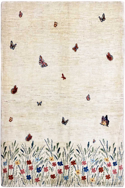Gabbeh Lori rug: beige woven rug with butterflies, floral border, and grasses