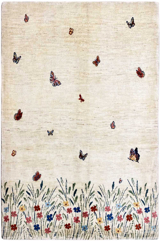 Gabbeh Lori rug: beige woven rug with butterflies, floral border, and grasses