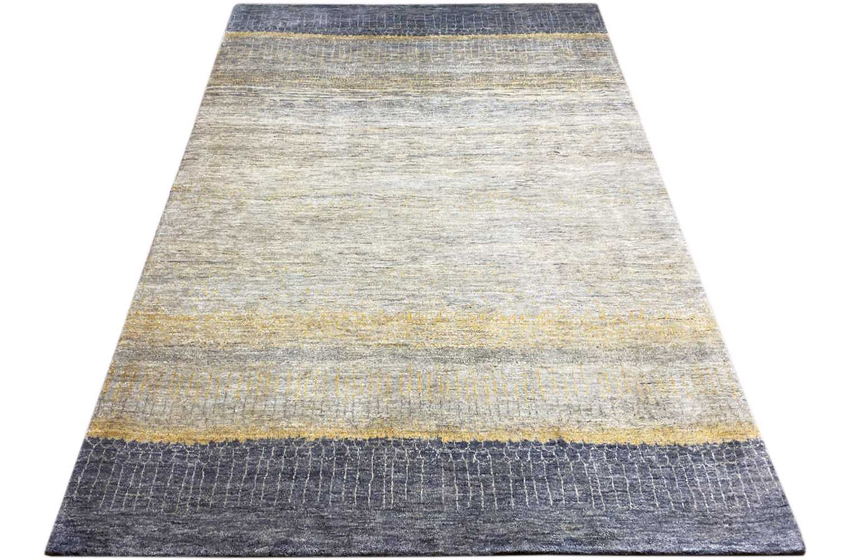 Rectangular Gabbeh-Lori rug with light areas and blue border stripes