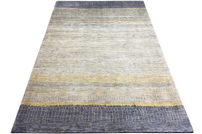Rectangular Gabbeh-Lori rug with light areas and blue border stripes