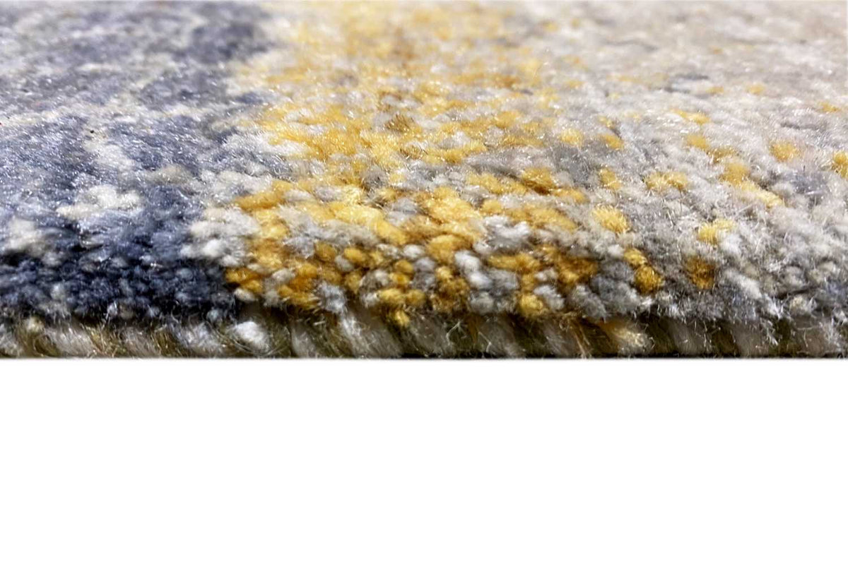 Carpet surface in detail: mottled texture with blue-gray and yellow accents