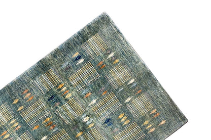 Gabbeh Lori rug corner with diagonal color blocks in blue-gray, orange, and cream