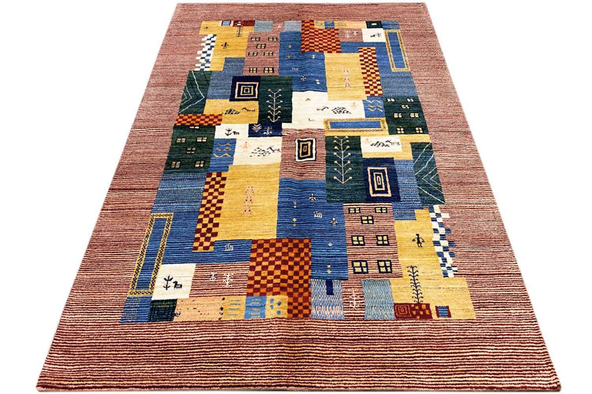 Gabbeh Lori rug shown in three-quarter view with patchwork squares in blue, yellow, and green