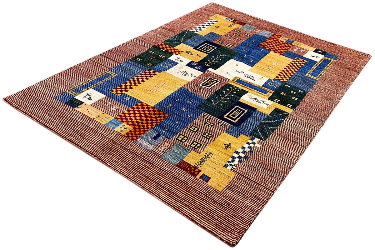 Gabbeh-Lori rug at an angle with a central patchwork pattern and contrasting border