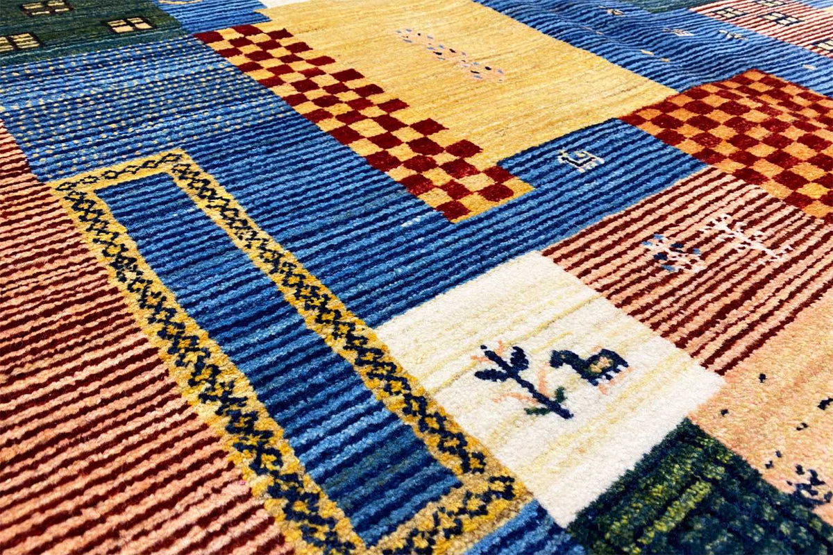 Gabbeh-Lori rug detail with blue stripes, yellow diamonds, and small symbols