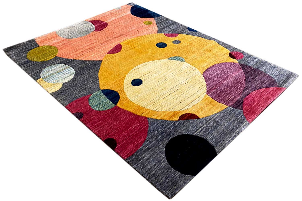 Gabbeh rug spread out, close-up view with a yellow animal shape, dots, and color fields