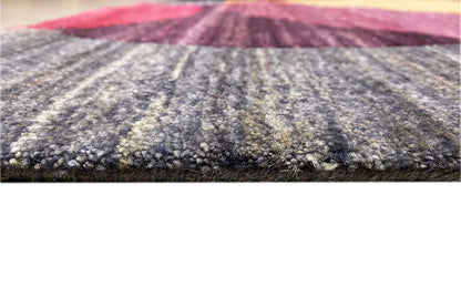 Gabbeh rug close-up of the pile surface and edge, dark gray with color accents