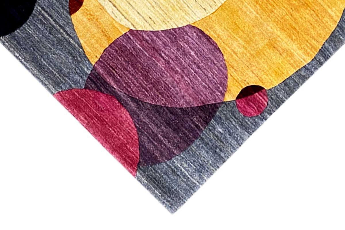 Gabbeh rug corner in diagonal view, yellow animal shape with purple and pink pattern
