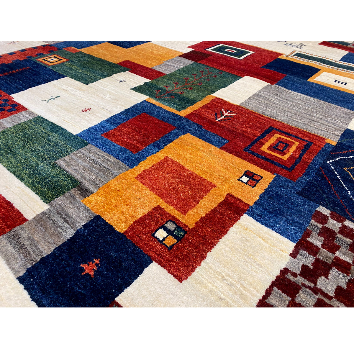 Gabbeh rug detail: Color fields and squares with an ornamental pattern in blue, red, and orange