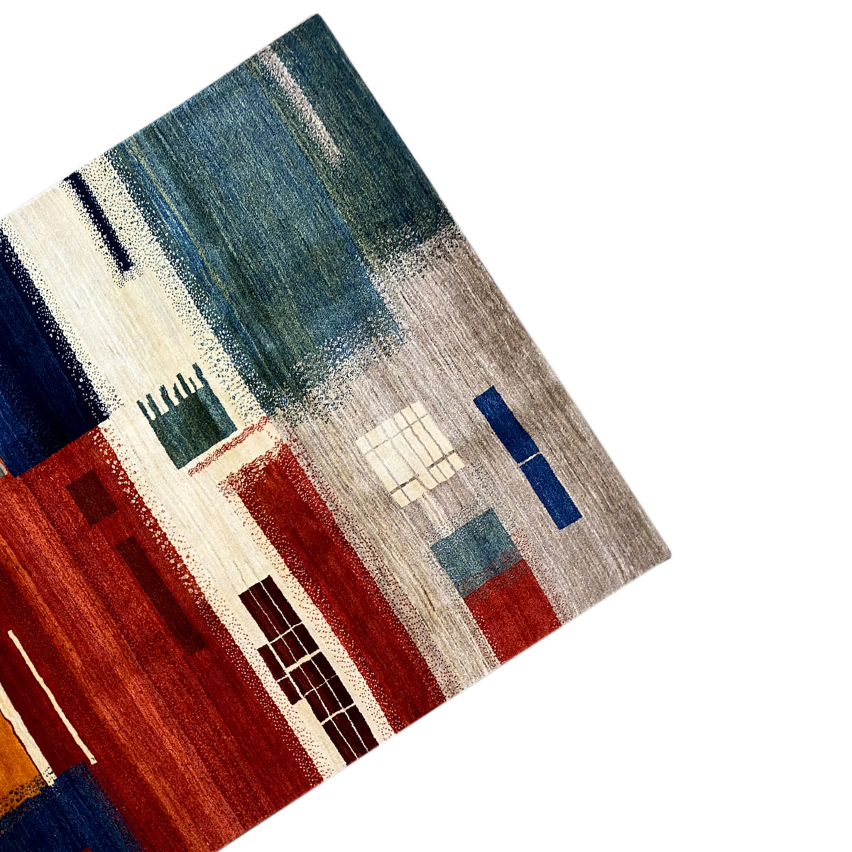 Close-up of a Gabbeh rug: patchwork pattern in blue, green, red, and beige
