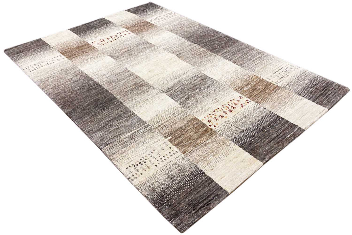 Wool rug with diagonal block sections in shades of gray, beige, and white