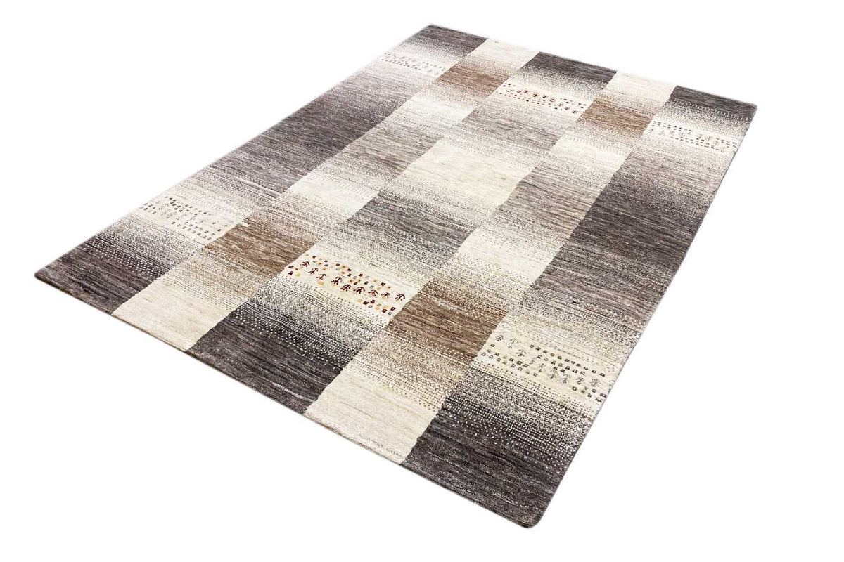 Wool rug with a checkered pattern of cream-colored and dark gray blocks
