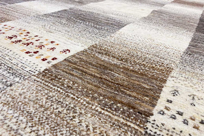 Close-up: wool rug with block sections and fine yarn textures in beige and dark gray